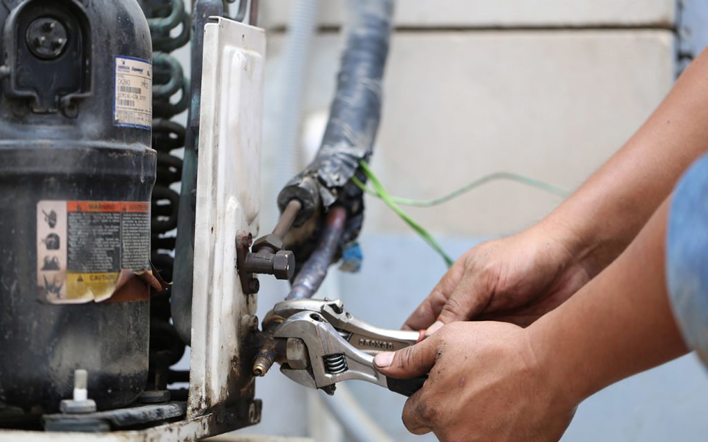 mechanic fixing HVAC system